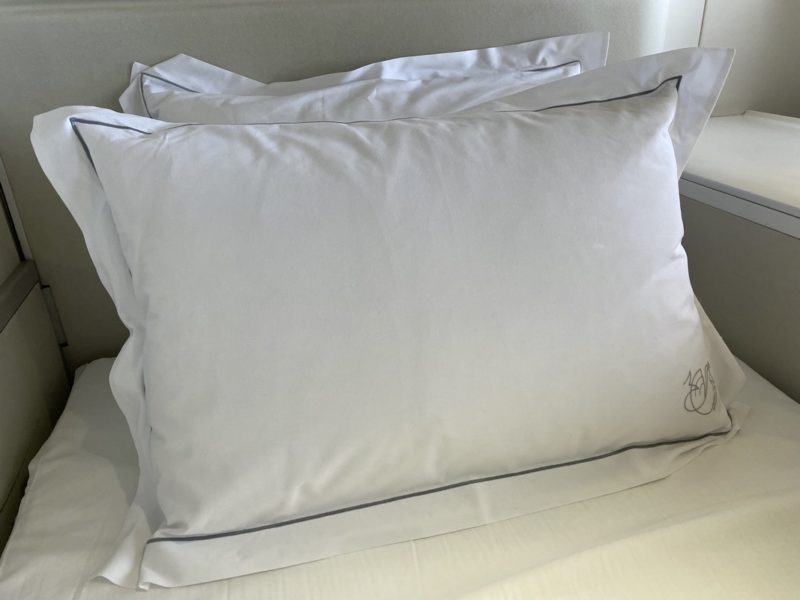 a white pillow on a bed
