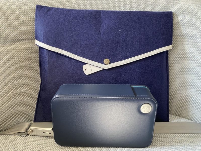 a blue case and a blue bag on a seat