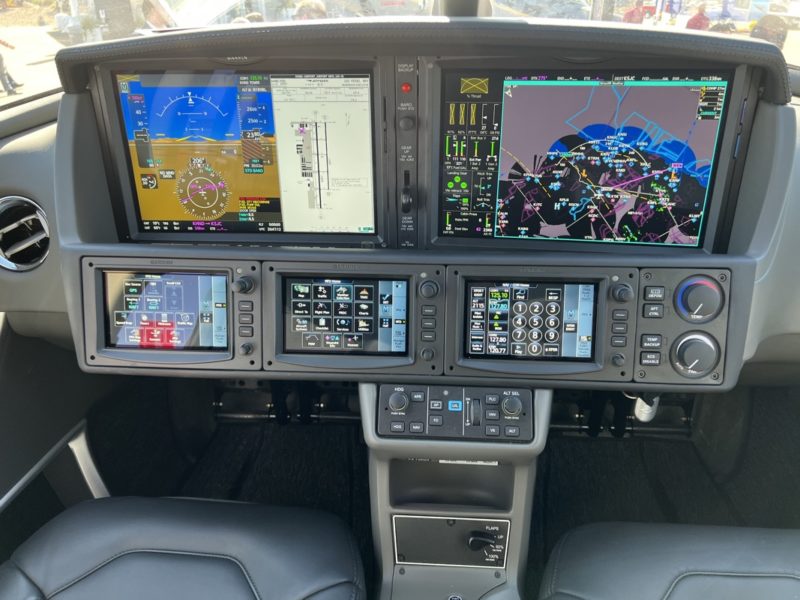the cockpit of a plane with multiple screens