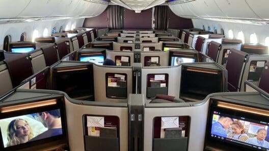 a row of seats with monitors on the side