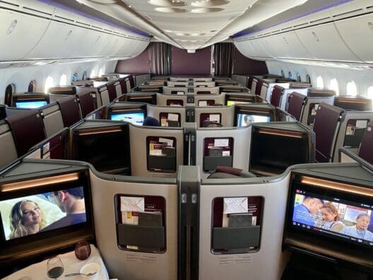 a row of seats with monitors on the side