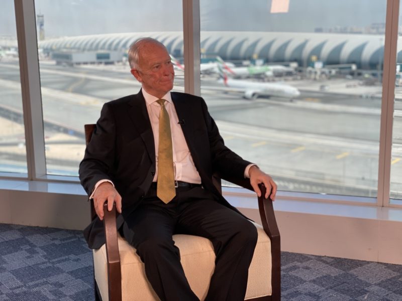 a man in a suit sitting in a chair