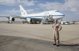 a woman standing in front of a plane