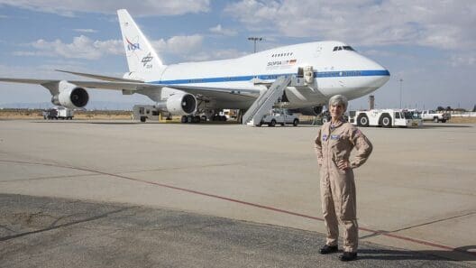 a woman standing in front of a plane