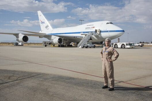 a woman standing in front of a plane