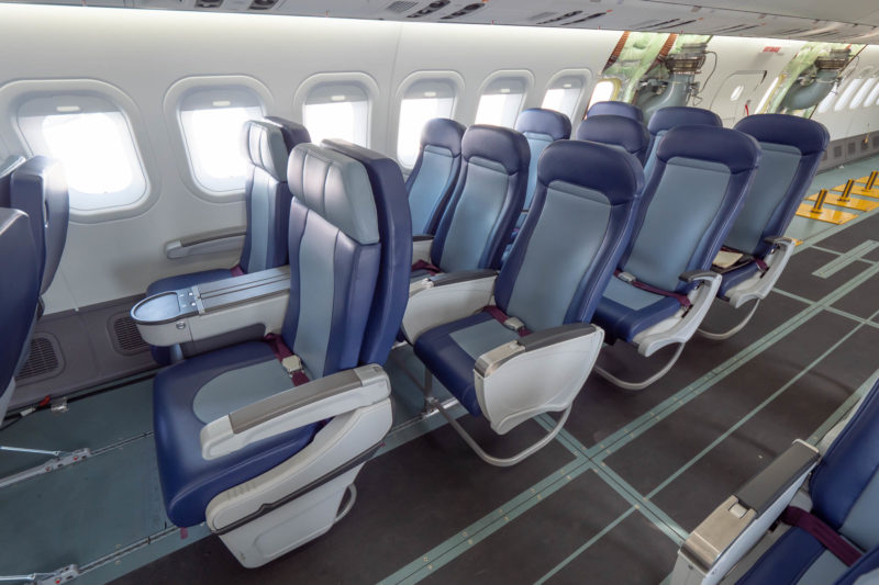 a row of blue and white seats on an airplane