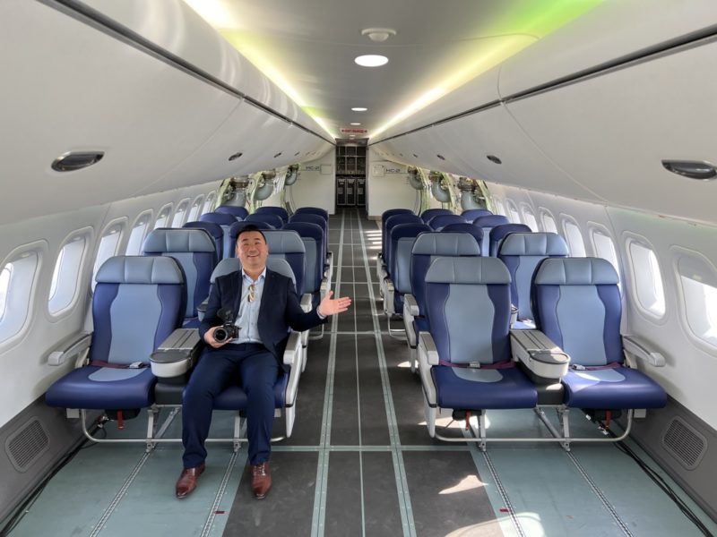 a man in a suit sitting in an airplane