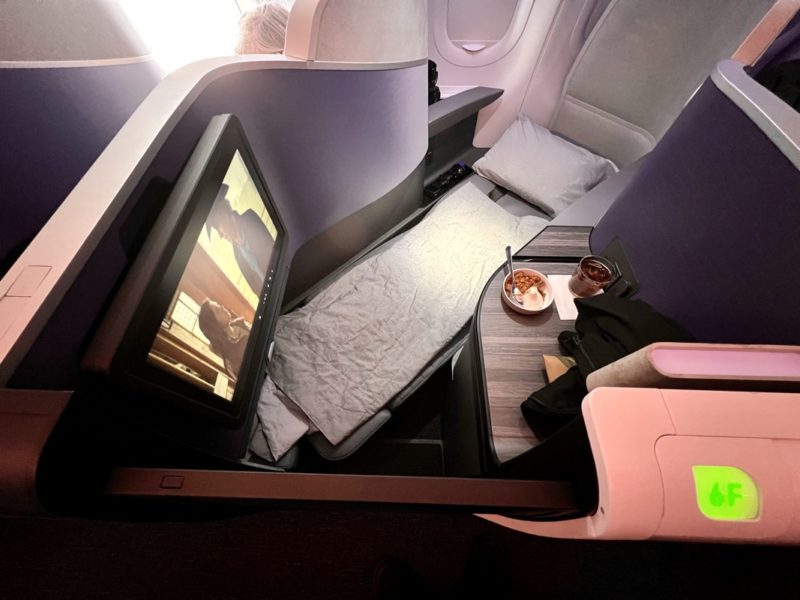 a tv on a bed in a plane
