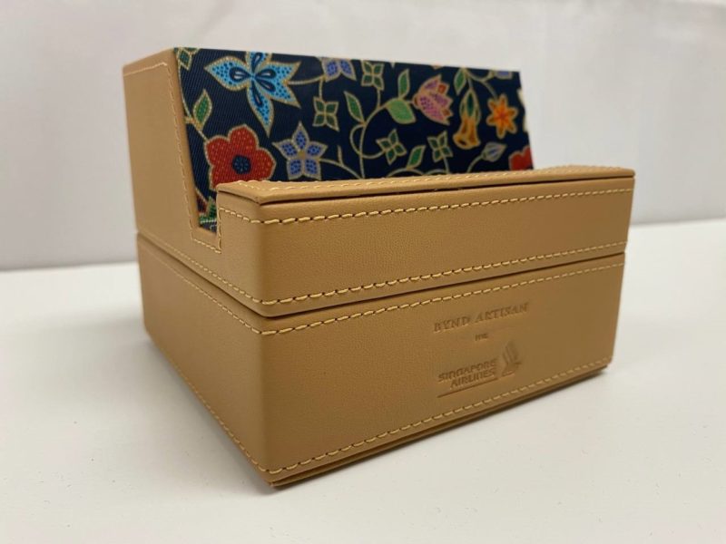 a tan box with a floral design inside
