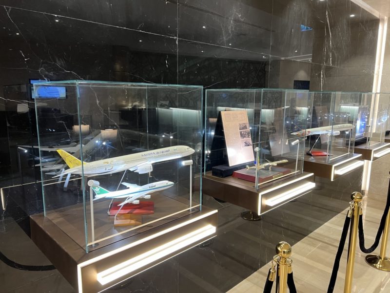a group of model airplanes in glass cases