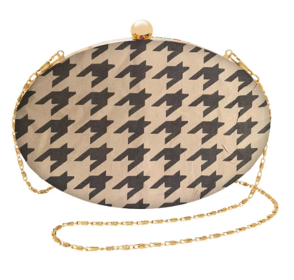 a black and white oval purse with a gold chain
