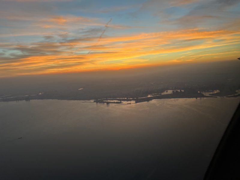 an aerial view of a body of water with a city in the distance