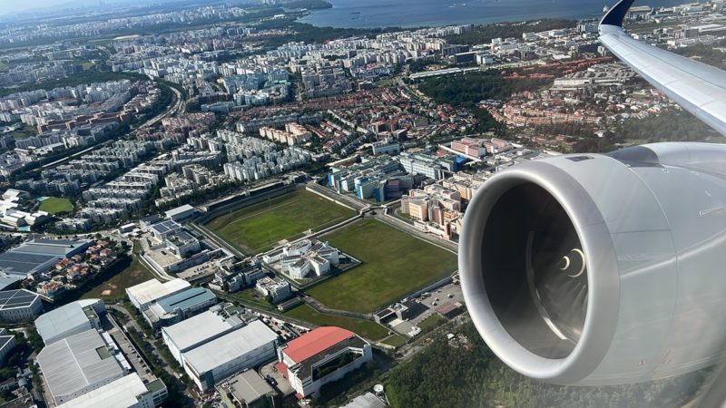 an airplane wing and city