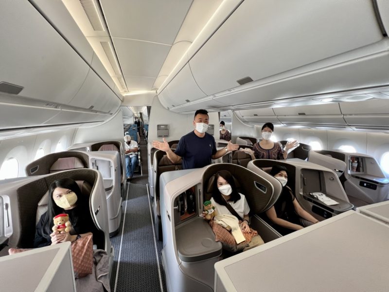 a group of people in a plane with masks