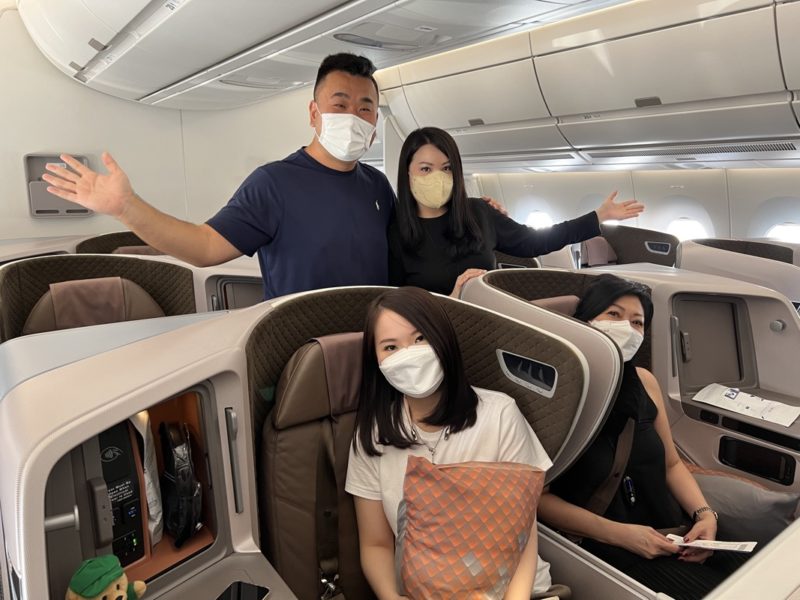 a group of people in a plane with masks