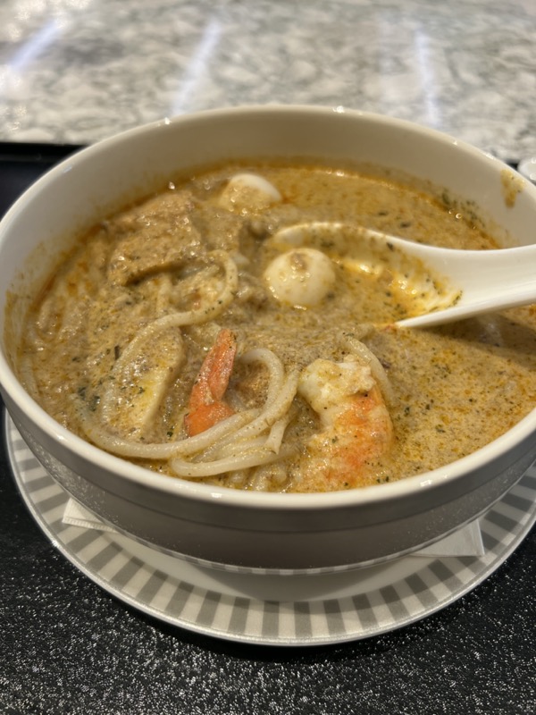 a bowl of soup with shrimp and noodles