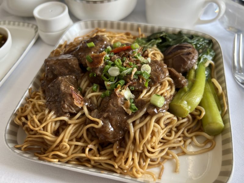 a plate of noodles and meat