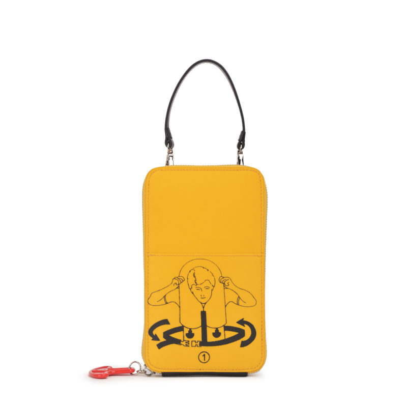 a yellow purse with a red keychain