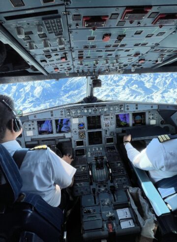two men in the cockpit of an airplane