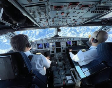 two men in the cockpit of an airplane