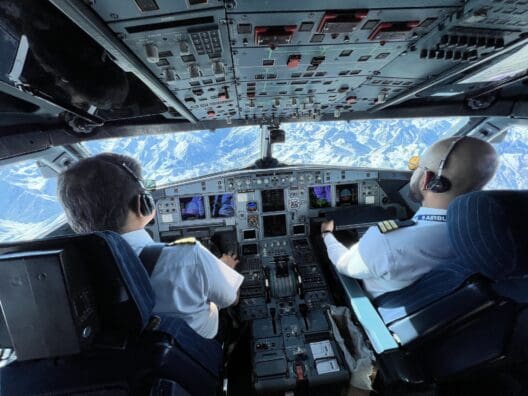 two men in the cockpit of an airplane