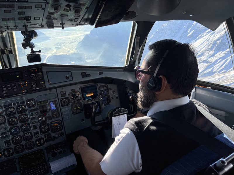 a man in a cockpit of an airplane