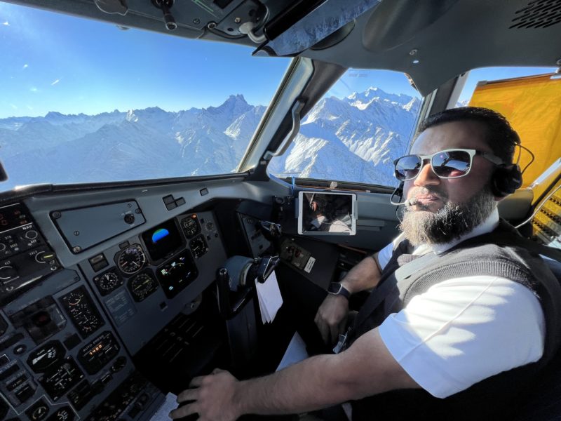 a man in sunglasses in a cockpit of a plane