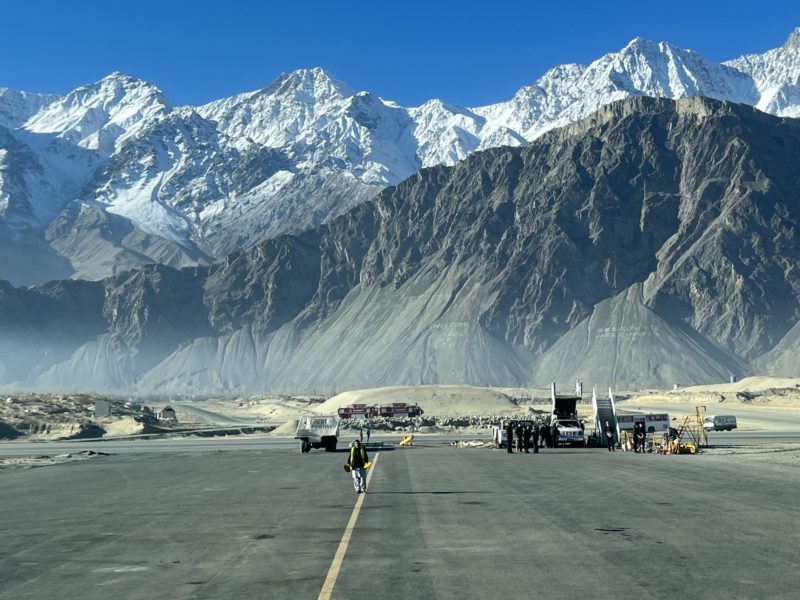 a runway with mountains in the background