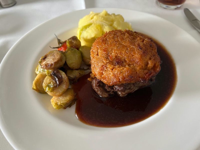 a plate of food with a piece of meat and vegetables