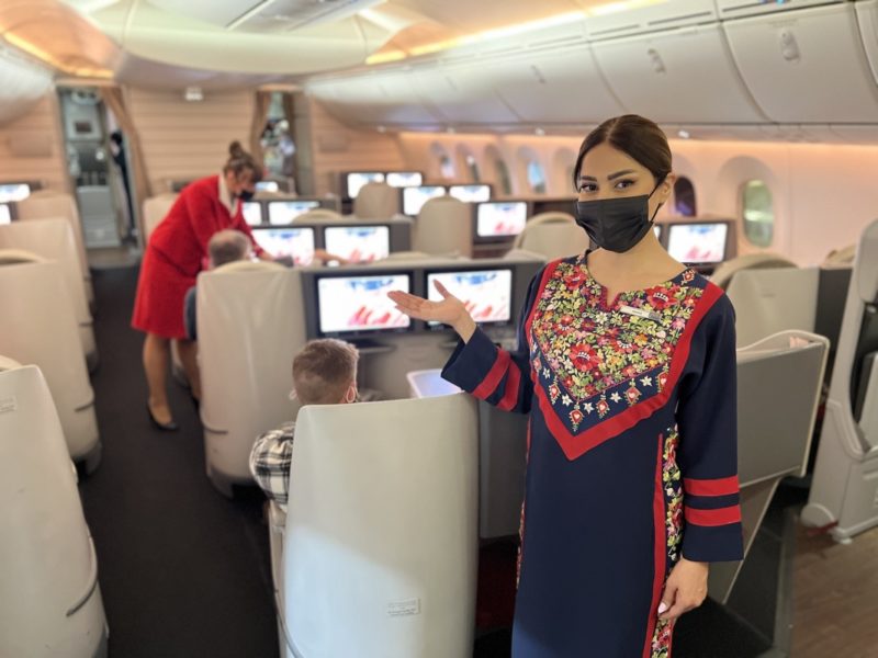 a woman wearing a face mask in an airplane