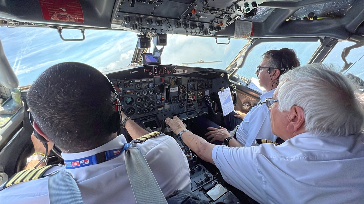 a group of people in a cockpit of a plane
