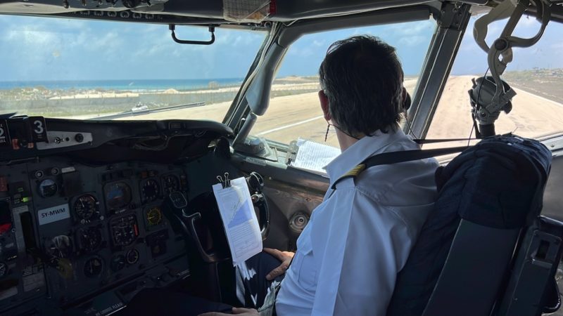 a man in a cockpit of a plane