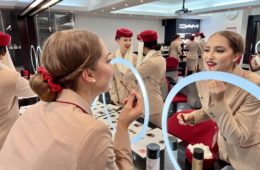 a woman in a uniform looking at a mirror