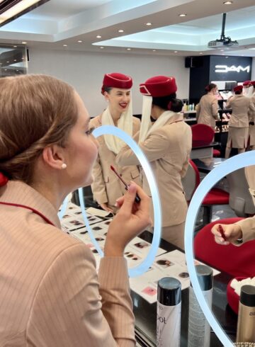 a woman in a uniform looking at a mirror