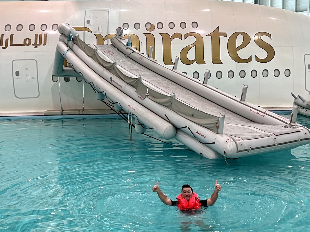 a man in a swimming pool with a jet slide