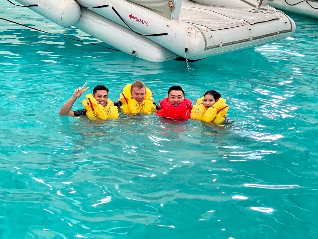 a group of people in a pool with life jackets