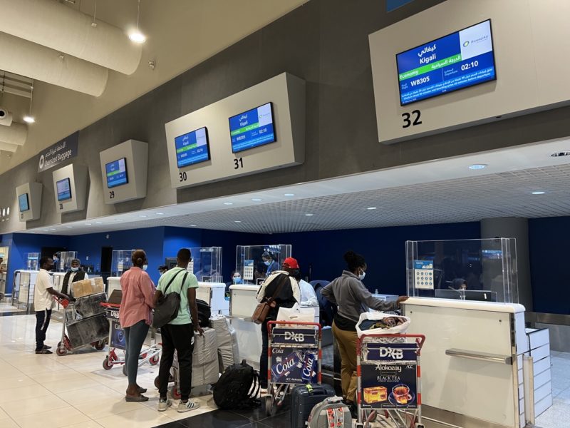 people standing in a line at a check-in counter