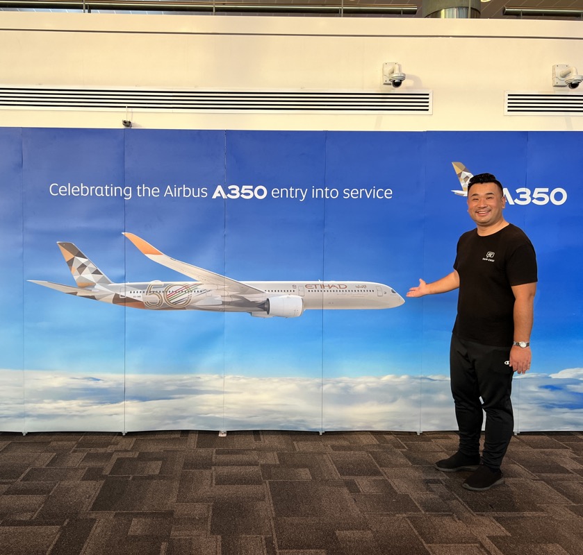 a man standing in front of a large banner