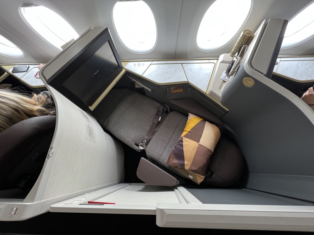 an airplane with a seat and a pillow