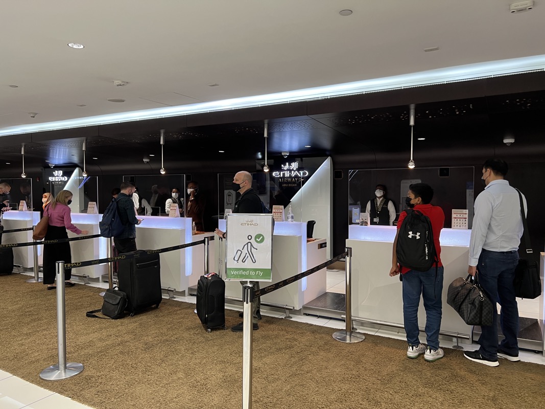 people standing in a line at a check in counter