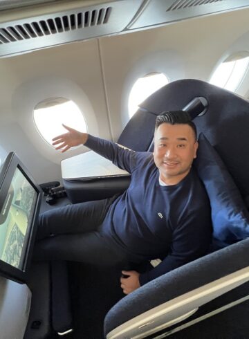 a man sitting in a chair in an airplane