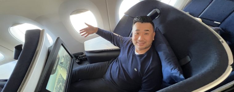 a man sitting in a chair in an airplane