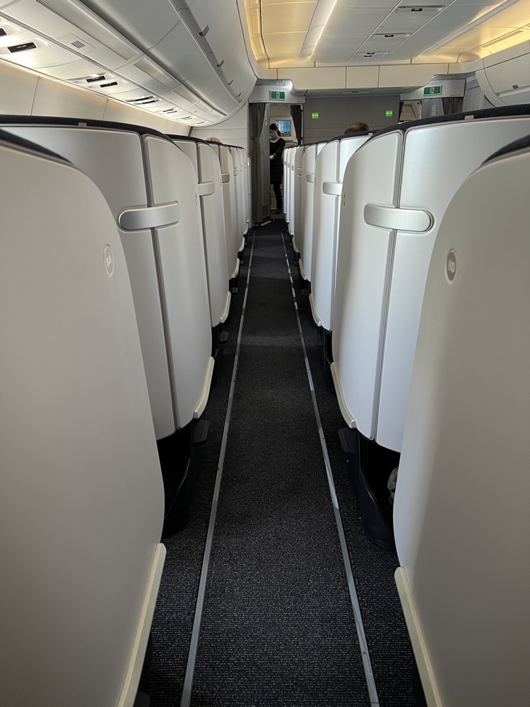 a row of white chairs on an airplane