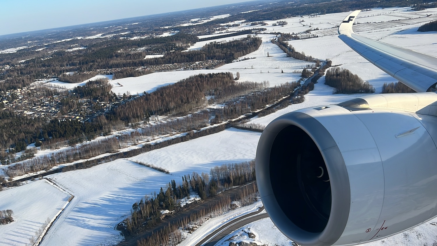an airplane engine above a snowy landscape