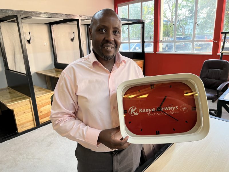 Kenya Airways CEO Allan Kilavuka showing some airline recycled collectibles