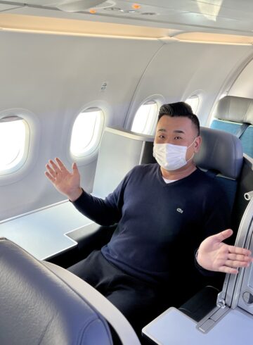 a man in a mask on an airplane