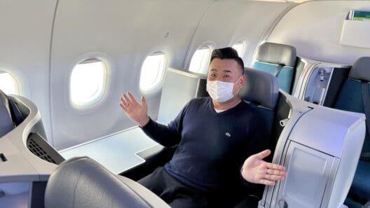 a man in a mask on an airplane