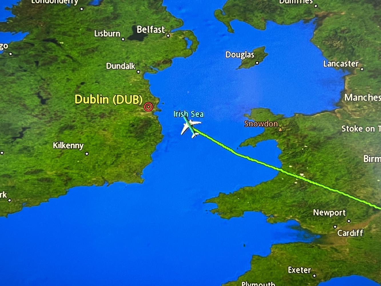 a map of ireland with a plane flying over the water