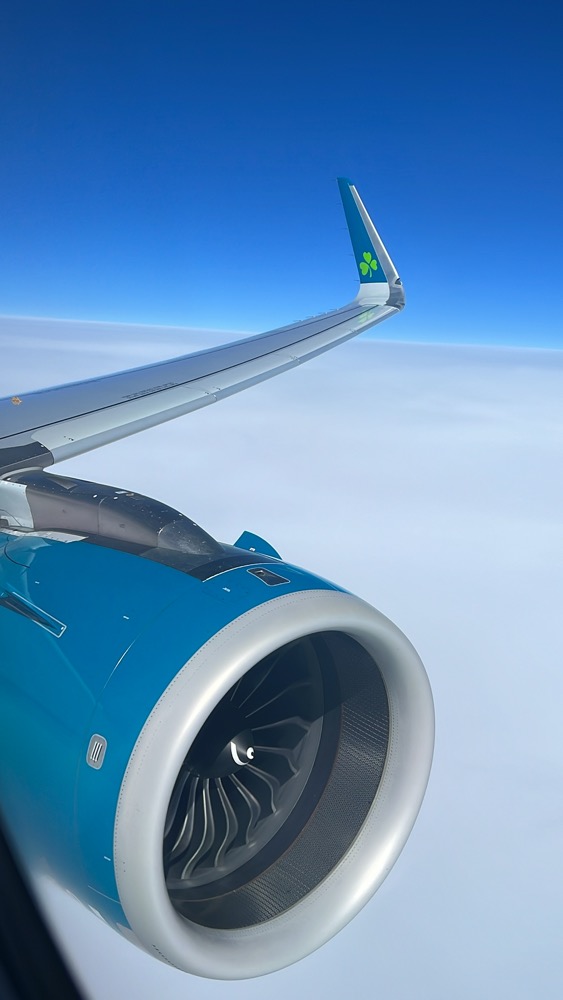 an airplane wing and a blue sky