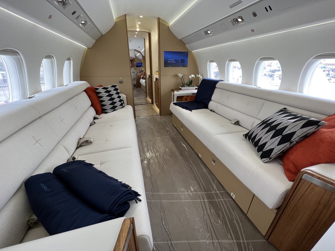 a white and blue couches in a plane